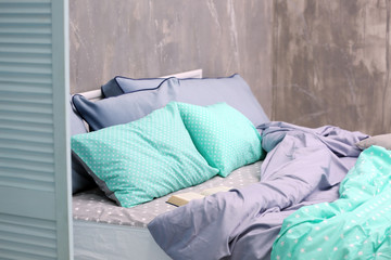 Comfortable bed with pillows in bedroom