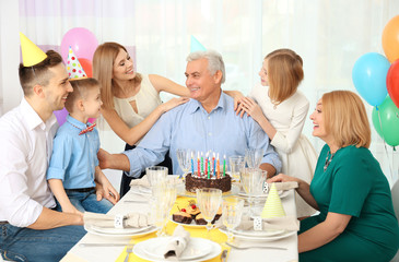 Family celebrating grandfather's birthday together