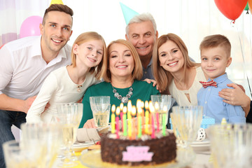 Family celebrating birthday with cake