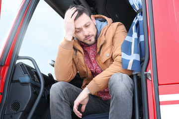 Driver in cabin of big modern truck