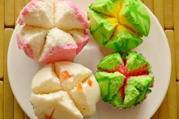 assorted colorful cotton cupcake in paper on plate