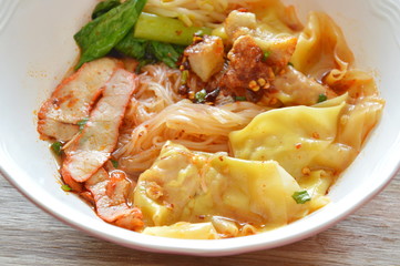 thin rice noodle topping dumpling and slice barbecue pork in soup