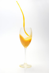 splash of orange juice in the glass on white background