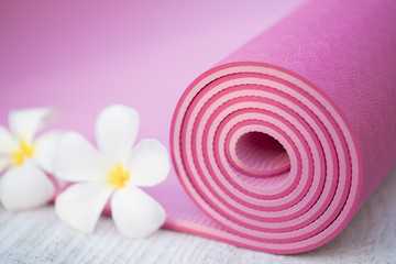 pink yoga mat and a flowers
