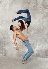 Couple ballet dancing on wall background