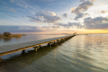 Fototapeta na wymiar wooden pier overlooking the lake, the beautiful evening sky