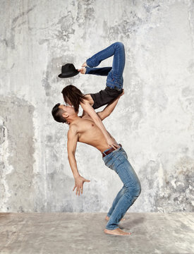 Couple ballet dancing on wall background