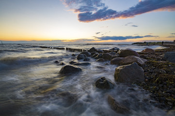 sea landscape, waves breaking on the breakwater pile of wood, baltic sea

