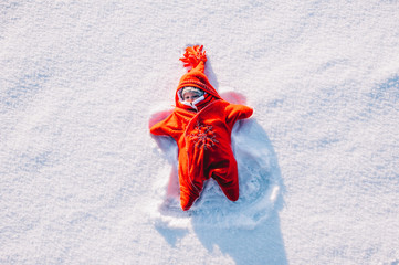 little girl lying on snow