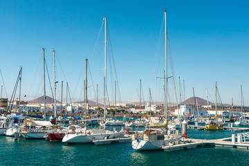 Fototapeta na wymiar Yachts with their masts up in city harbor, Spain