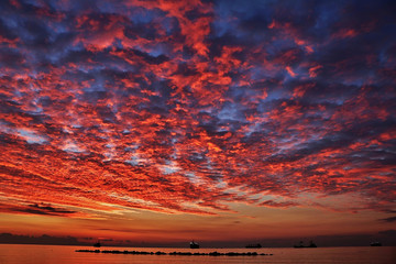 Romantic sky at sunset or sunrise over the calm sea
