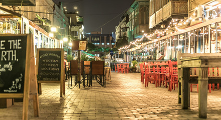 Street of Tbilisi late at night, restaurants - obrazy, fototapety, plakaty