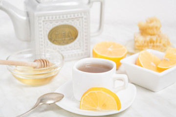 A cup of tea with lemon and honey for health