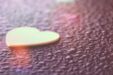 the heart shape wood on the rain drops and the sunlights