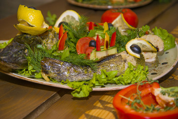 Stuffed pike with vegetables and herbs.