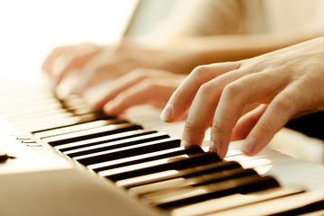 Fototapeta premium Closeup of hands playing piano. Music and hobby concept