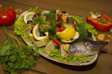 Stuffed pike with vegetables and herbs.