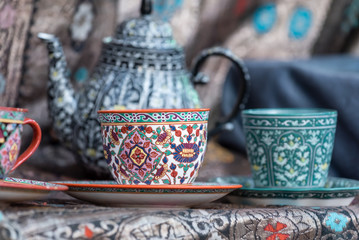 vintage tea cup painted in colorful floral pattern