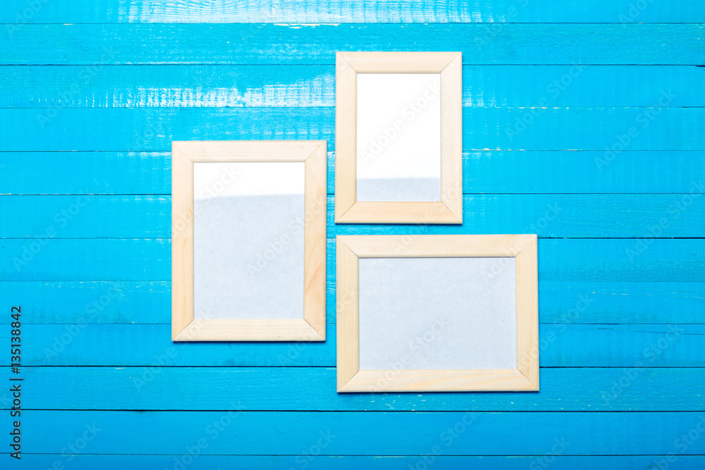 Poster  photo frames on the wooden wall