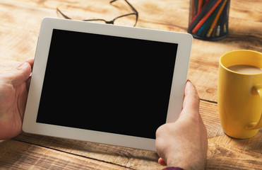 Male hands holding a white tablet with copy space