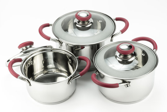 Stainless steel cooking pots with lids isolated on white backgro