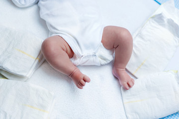 Obraz na płótnie Canvas Feet of newborn baby boy or girl on changing table