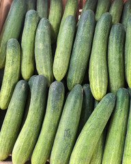 Fresh cucumber on wood box in market