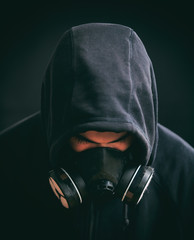 Hooded man on black background