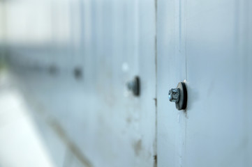 Facade lined with metal panels. Fixing element closeup selective focus.