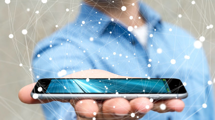 Businessman holding flying network sphere over his mobile phone