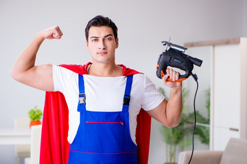 Superhero repairman with tools in repair concept