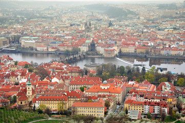 Fototapeta na wymiar Aerial panoramic view of the historic center of Prague, Czech Republic. River Vltava, red tiled roofs and towers in perspective.