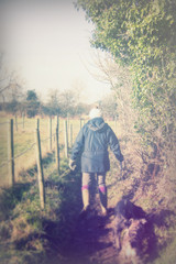 Beautiful woman walking dogs in the countryside