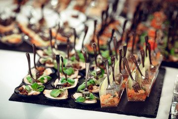 Appetizers and salads with forks close-up