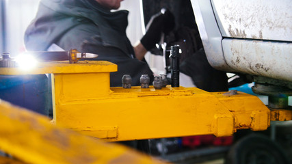 Car in auto service lifting for repairing, slider