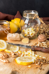 Fototapeta na wymiar Healthy food: mix of lemon, germinated wheat, walnuts, honey, g
