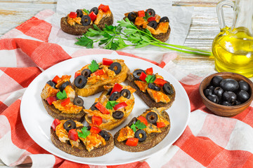 whole grain rye Crostini with pieces of mackerel fish