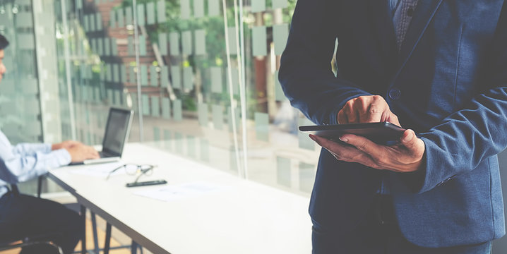 Man Use Smartphone Hand,touch screen.Project Manager Researching Process.Business Team Work Startup modern Office.