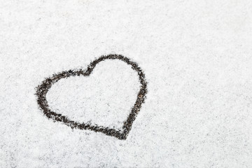 heart drawn in the snow background. Decoration on the day of valentine or love