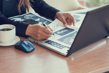 Close Up of woman hands using mobile phone and laptop computer with blank copy space screen for your advertising text message or content business in the Vintage effect.