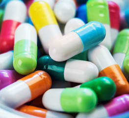 pills of different colors background. Very little depth of field