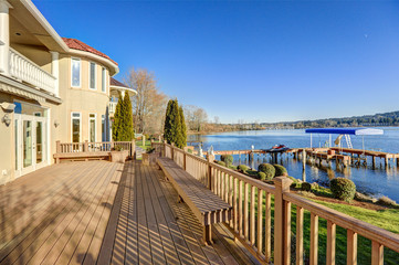 Fototapeta na wymiar Sunny spacious walkout deck of luxurious waterfront home
