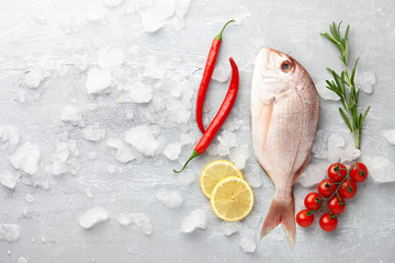 Fish cooking: fresh red Japanese seabream, lemon slices, chili pepper, cherry tomatoes and rosemary...