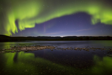 Fototapeta na wymiar Aurora Borealis over the river. River Paypudyna. Polar Urals. Russia.
