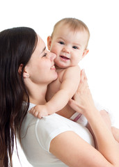 Happy family. A young mother with baby kissing and hugging.