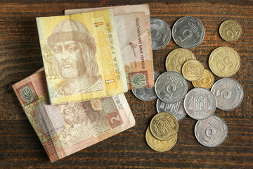 Hryvnia a penny lying on the wooden background. The concept of poverty.