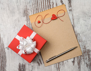 coffee and empty notepad with red gift box