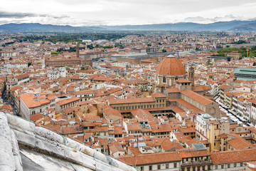 Fototapeta premium Cloudy view of Florence from viewpoint at top of the dome of Santa Maria del Fiore, Toscana region, Italy.