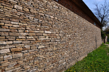 Wall from natural river stone used for construction of housing and commercial buildings