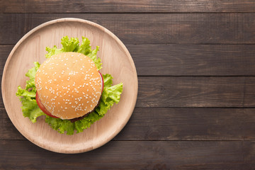 Top view BBQ burger on wooden dish on wooden background. 